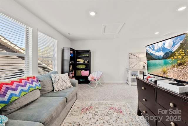 living room with baseboards, recessed lighting, attic access, and light colored carpet