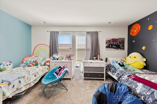 bedroom with visible vents and carpet flooring