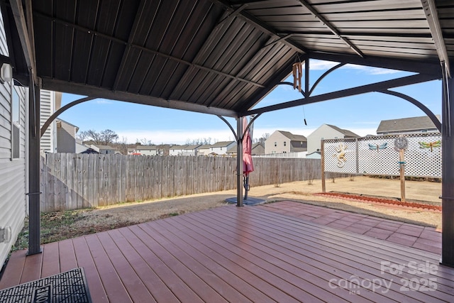 wooden deck with a fenced backyard