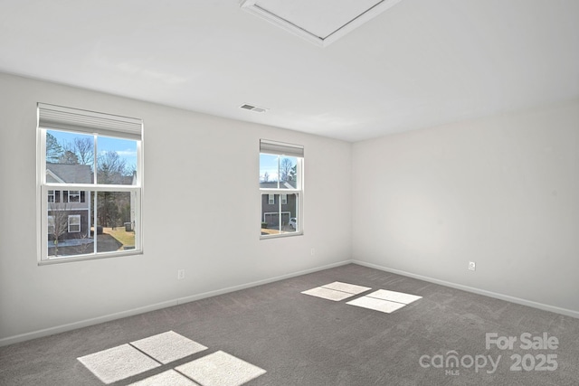 unfurnished room with a healthy amount of sunlight, visible vents, and carpet flooring