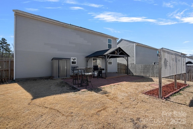 back of property featuring a patio, a lawn, and fence