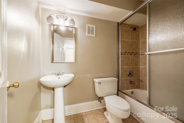 bathroom with enclosed tub / shower combo, toilet, visible vents, baseboards, and tile patterned floors