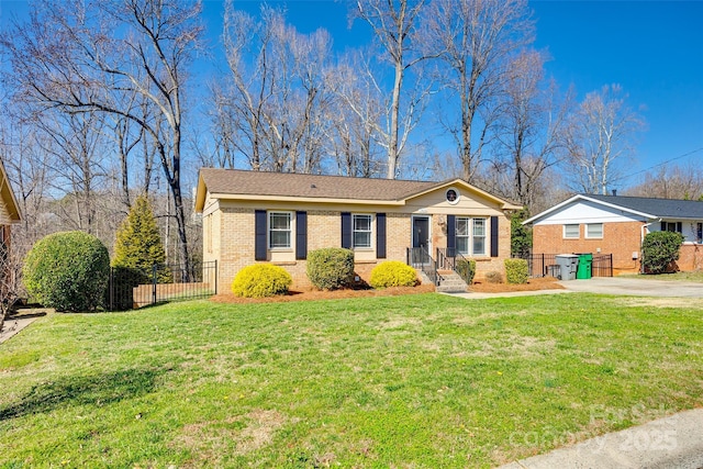 ranch-style house featuring a front yard, a gate, brick siding, and fence