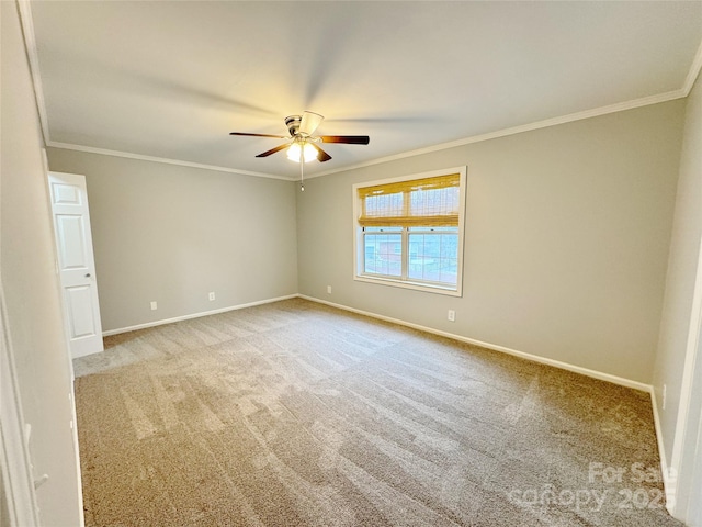 unfurnished room with baseboards, crown molding, and carpet flooring