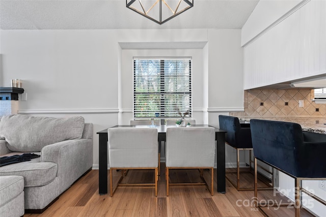 dining room with an inviting chandelier and wood finished floors