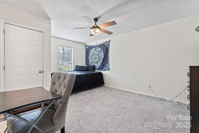 bedroom with carpet flooring, a ceiling fan, baseboards, and a textured ceiling