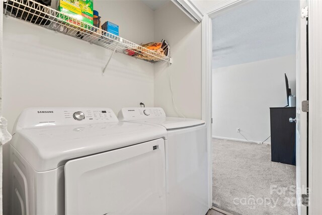 laundry room with washer and clothes dryer, carpet flooring, laundry area, and baseboards