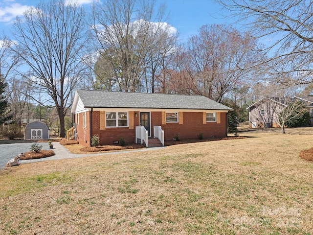 ranch-style house featuring a storage unit, crawl space, an outdoor structure, and brick siding