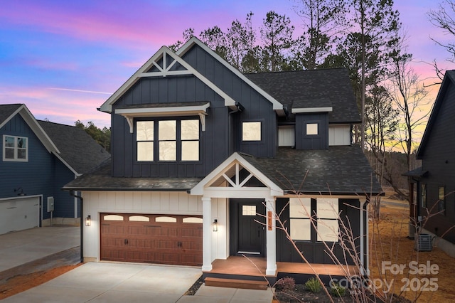 modern inspired farmhouse featuring roof with shingles, concrete driveway, an attached garage, central AC unit, and board and batten siding