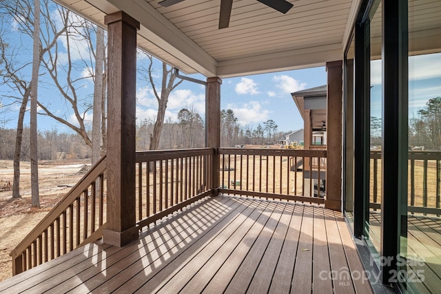 wooden deck featuring a ceiling fan