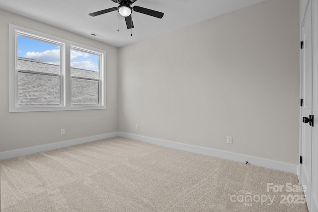 unfurnished room featuring ceiling fan, carpet, visible vents, and baseboards