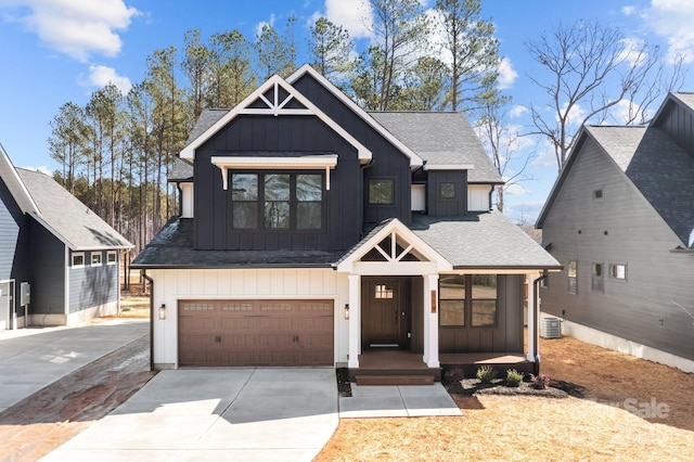 view of front facade with an attached garage, cooling unit, concrete driveway, roof with shingles, and board and batten siding