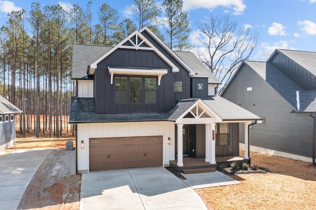 modern farmhouse featuring a shingled roof, concrete driveway, an attached garage, covered porch, and board and batten siding