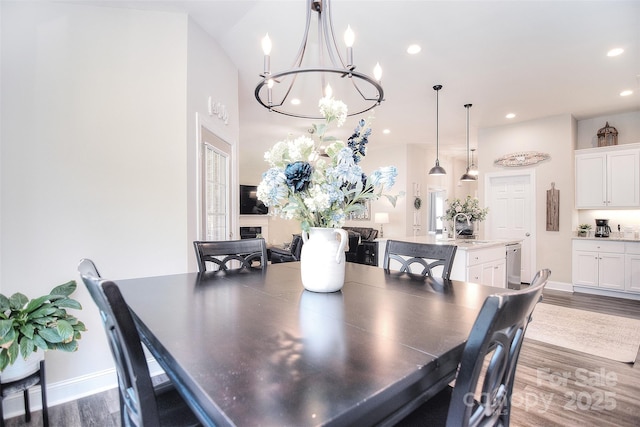 dining space featuring recessed lighting, baseboards, wood finished floors, and a fireplace