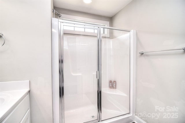 full bath with vanity and a stall shower