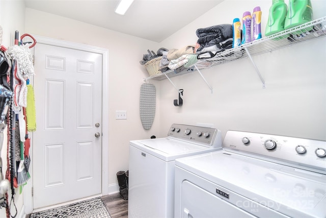 washroom with laundry area, wood finished floors, and washing machine and clothes dryer