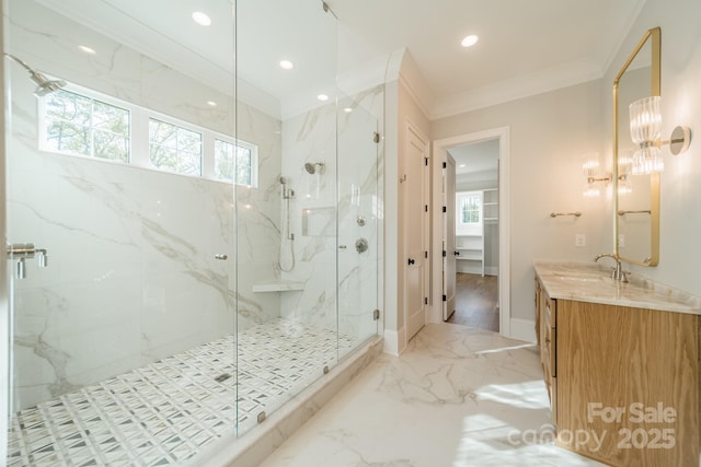 bathroom featuring plenty of natural light, marble finish floor, ornamental molding, and a marble finish shower