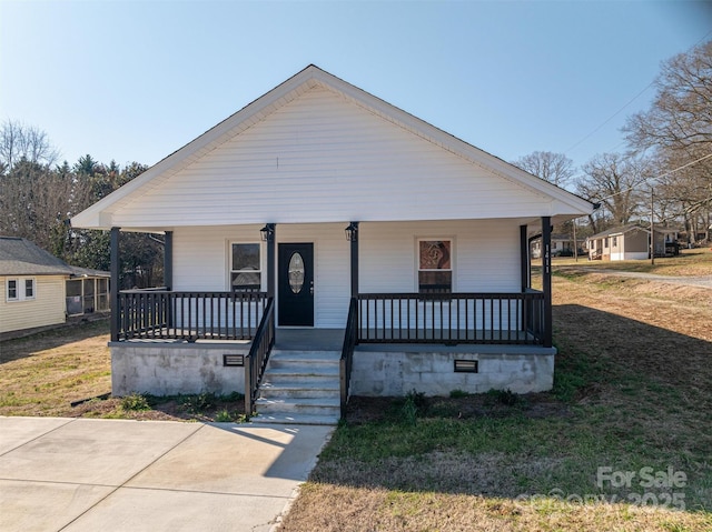 bungalow-style house featuring covered porch, a front lawn, and crawl space