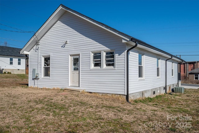 rear view of house with crawl space, central AC, and a yard
