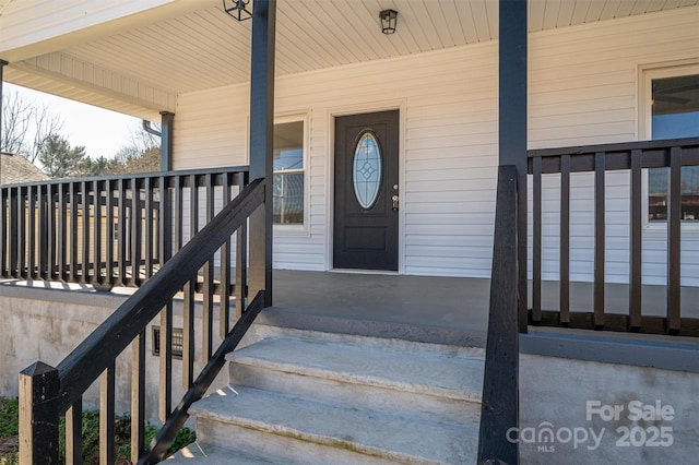 view of exterior entry featuring a porch
