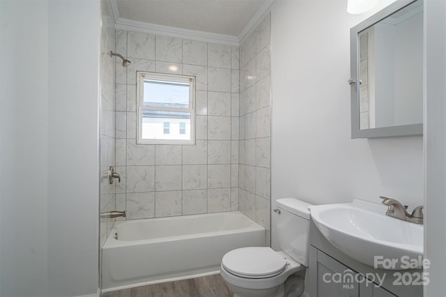 bathroom with bathing tub / shower combination, toilet, ornamental molding, wood finished floors, and vanity