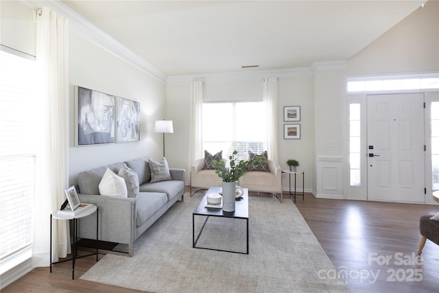 living room featuring ornamental molding, visible vents, and wood finished floors