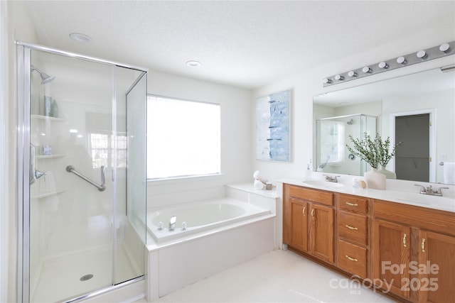 bathroom with a sink, double vanity, a shower stall, and a bath