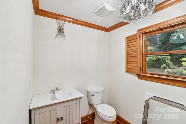 bathroom with toilet, visible vents, baseboards, wood finished floors, and vanity