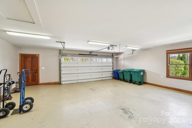 garage with baseboards and a garage door opener