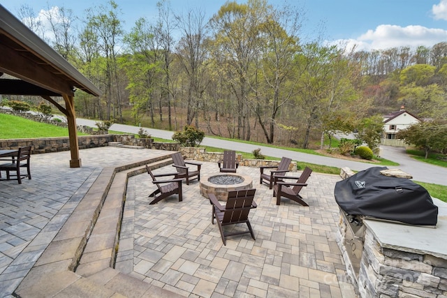 view of patio with a fire pit and a grill
