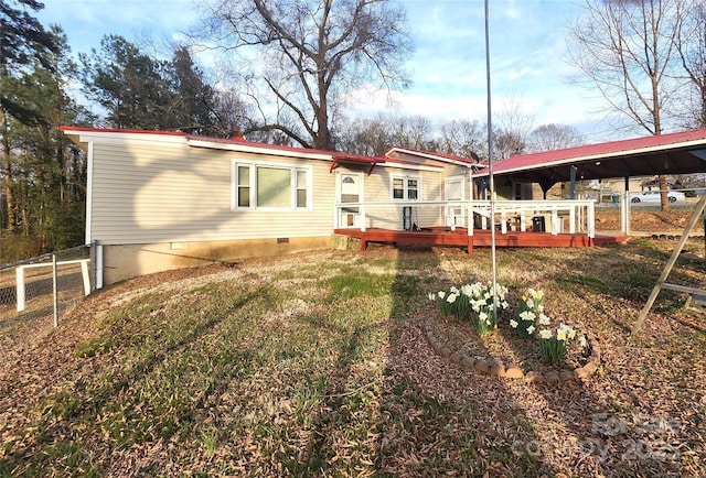 back of house with crawl space, fence, and a deck