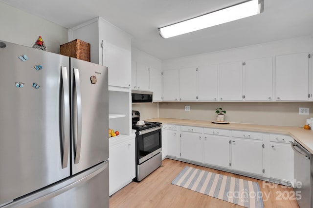 905 Blalock Dr, Kings Mountain, NC 28086 - kitchen featuring appliances with stainless steel finishes, light wood finished floors, white cabinets, and light countertops