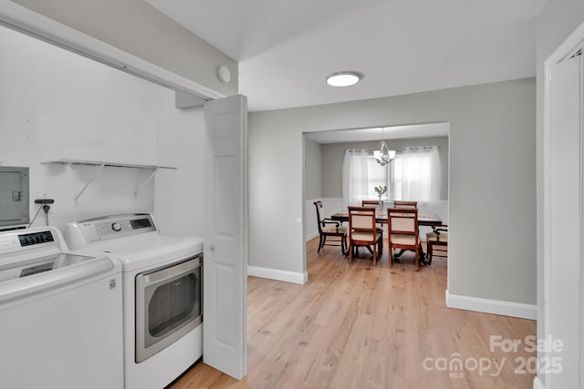 905 Blalock Dr, Kings Mountain, NC 28086 - laundry room with washer and clothes dryer, a chandelier, light wood-type flooring, and electric panel