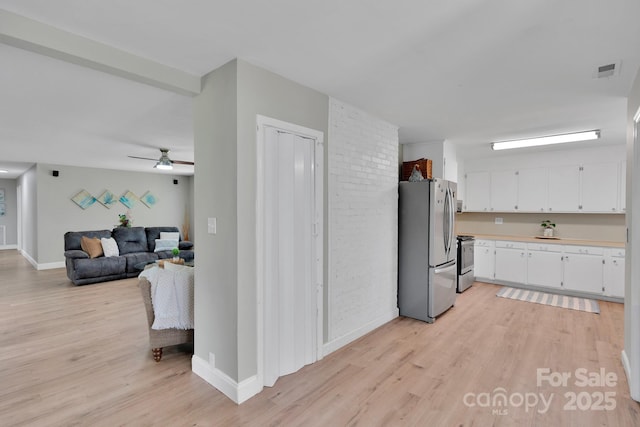 905 Blalock Dr, Kings Mountain, NC 28086 - kitchen with appliances with stainless steel finishes, light wood-style flooring, white cabinets, light countertops, and a ceiling fan