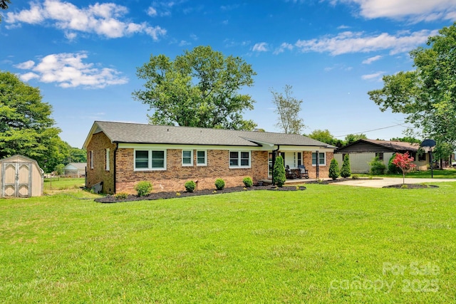 905 Blalock Dr, Kings Mountain, NC 28086 - ranch-style house featuring a storage unit, a patio area, a front lawn, and brick siding