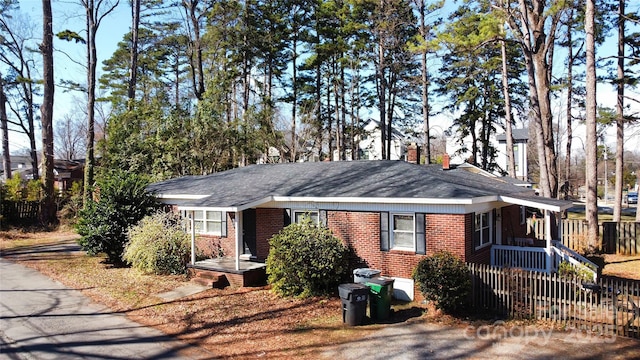 ranch-style home with brick siding and fence