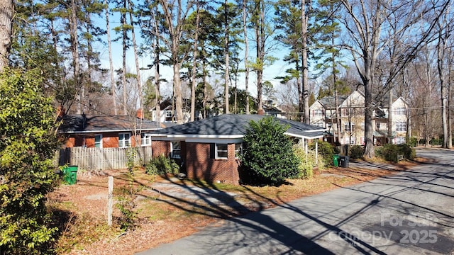 exterior space featuring crawl space, fence, and brick siding