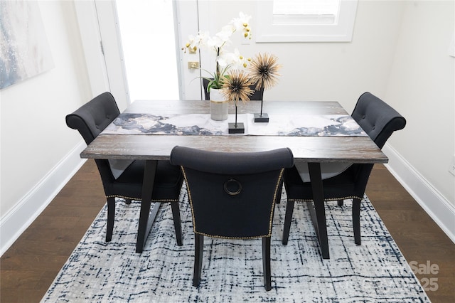 dining room with wood finished floors and baseboards