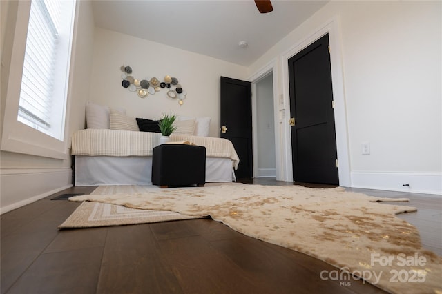 bedroom featuring baseboards and ceiling fan