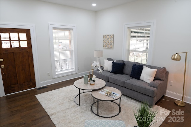 living room with recessed lighting, dark wood-style floors, visible vents, and baseboards