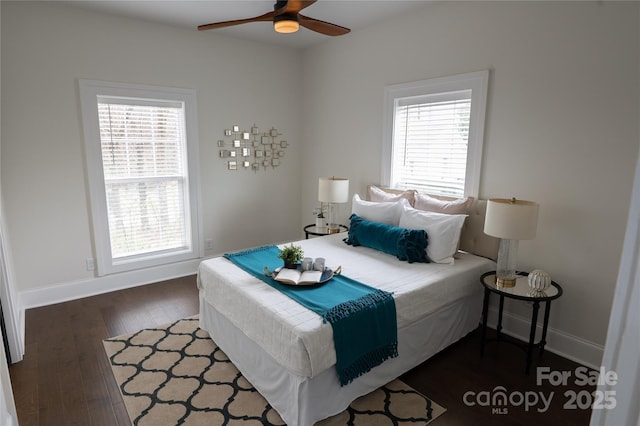 bedroom with dark wood finished floors, ceiling fan, and baseboards