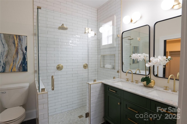 full bathroom featuring a sink, toilet, a stall shower, and double vanity