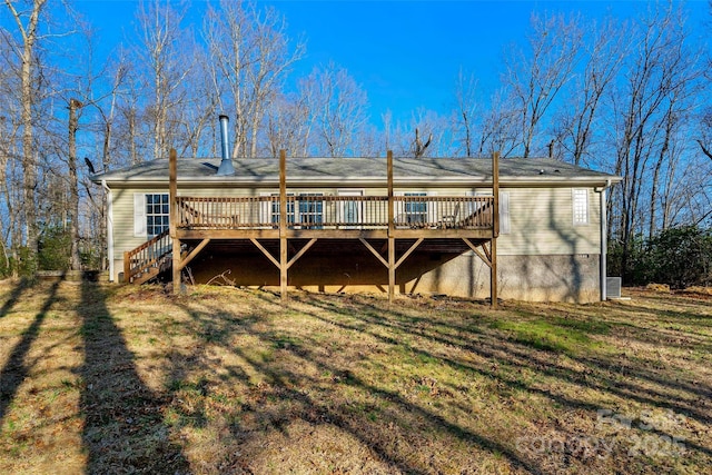 back of property featuring a yard and a wooden deck