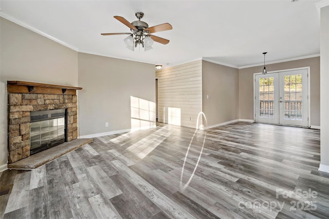 unfurnished living room featuring ceiling fan, french doors, wood finished floors, and crown molding