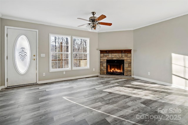 unfurnished living room with baseboards, wood finished floors, ceiling fan, and ornamental molding