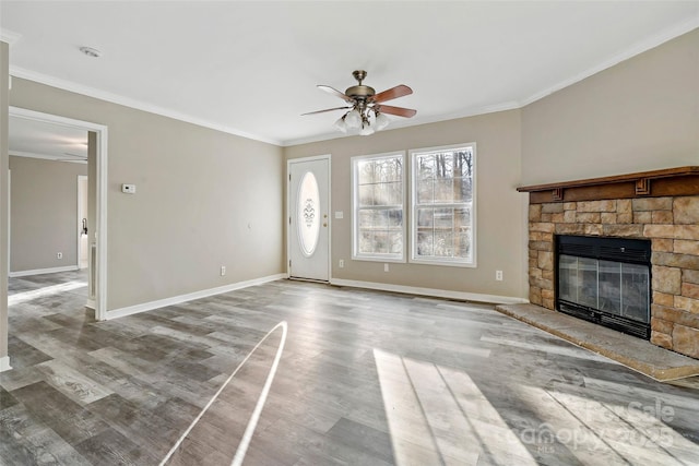 unfurnished living room with crown molding, baseboards, ceiling fan, a fireplace, and wood finished floors