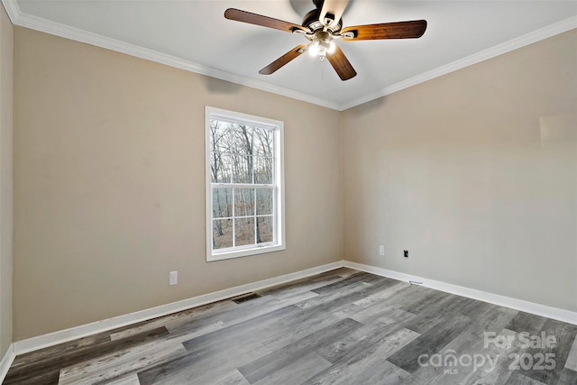 empty room featuring visible vents, crown molding, ceiling fan, and wood finished floors