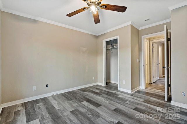 unfurnished bedroom featuring a ceiling fan, baseboards, dark wood finished floors, ornamental molding, and a closet