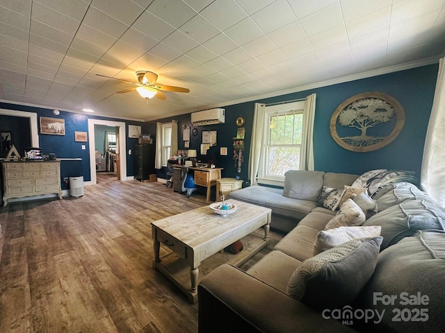 living room with wood finished floors, baseboards, a wall mounted air conditioner, and ornamental molding