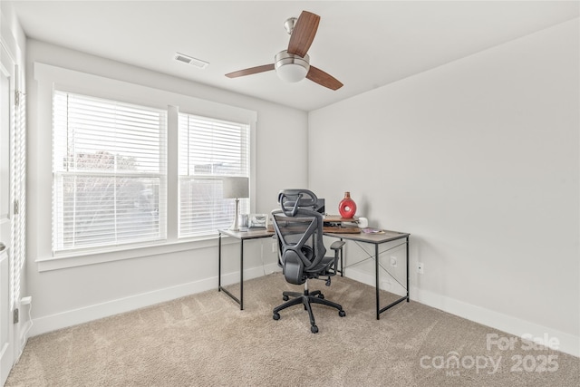 office space with a ceiling fan, carpet, visible vents, and baseboards